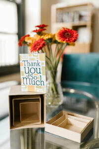 photo of flowers and a card that reads Thank you.